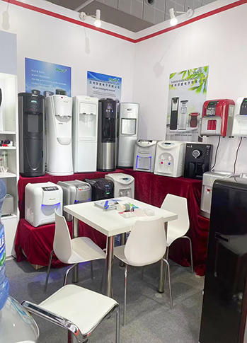 How do I clean and sanitize my hot and cold water dispenser?